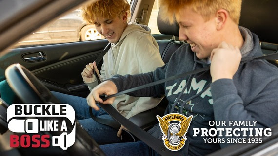 teens buckling up in a vehicle